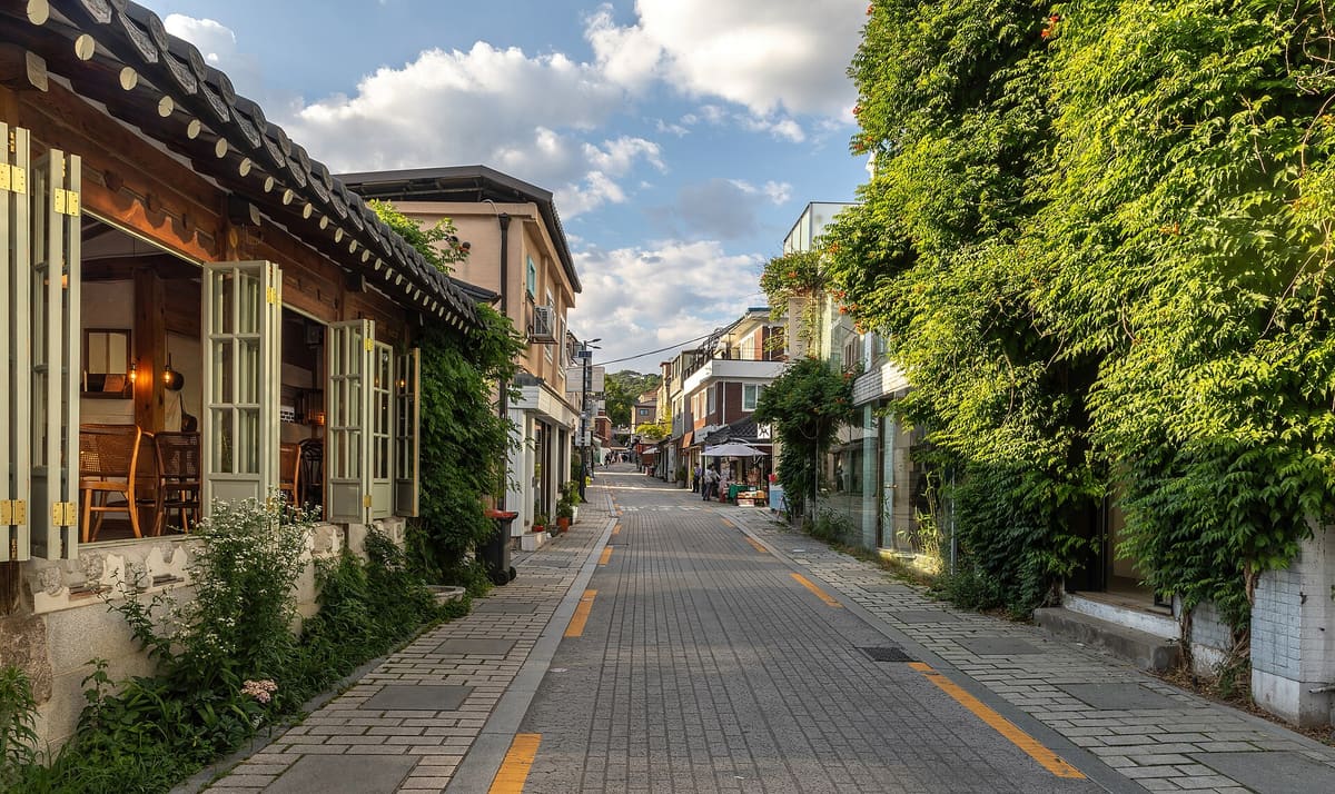 Bukchon Hanok Village — Gyedong-gil street with climbing plants at golden hour in Seoul South Korea