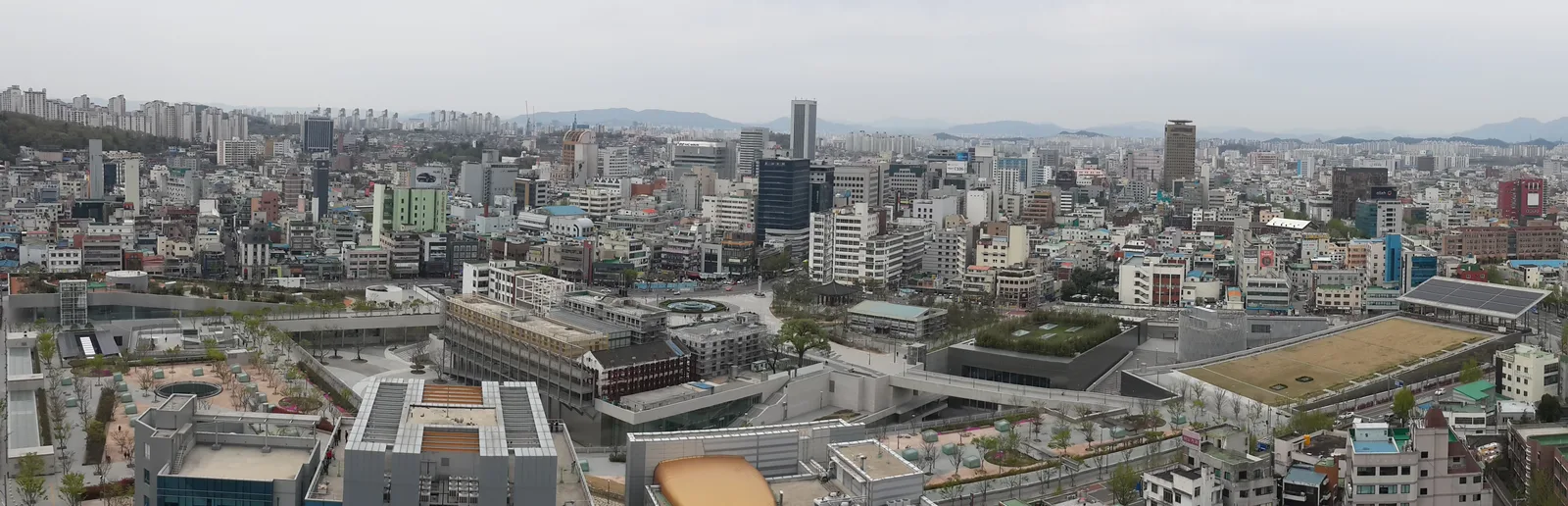 An elevated panorama over the real Asia Culture Center’s low buildings, green roofs and broad plaza in central Gwangju