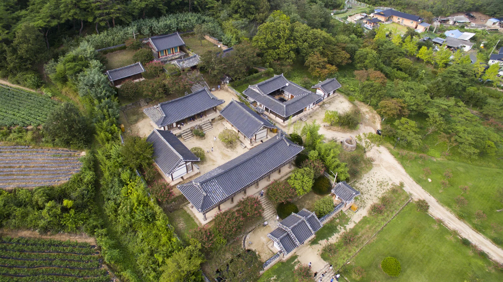 Byeongsan Seowon's timber halls and tiled courtyards between green fields and the wooded hillside