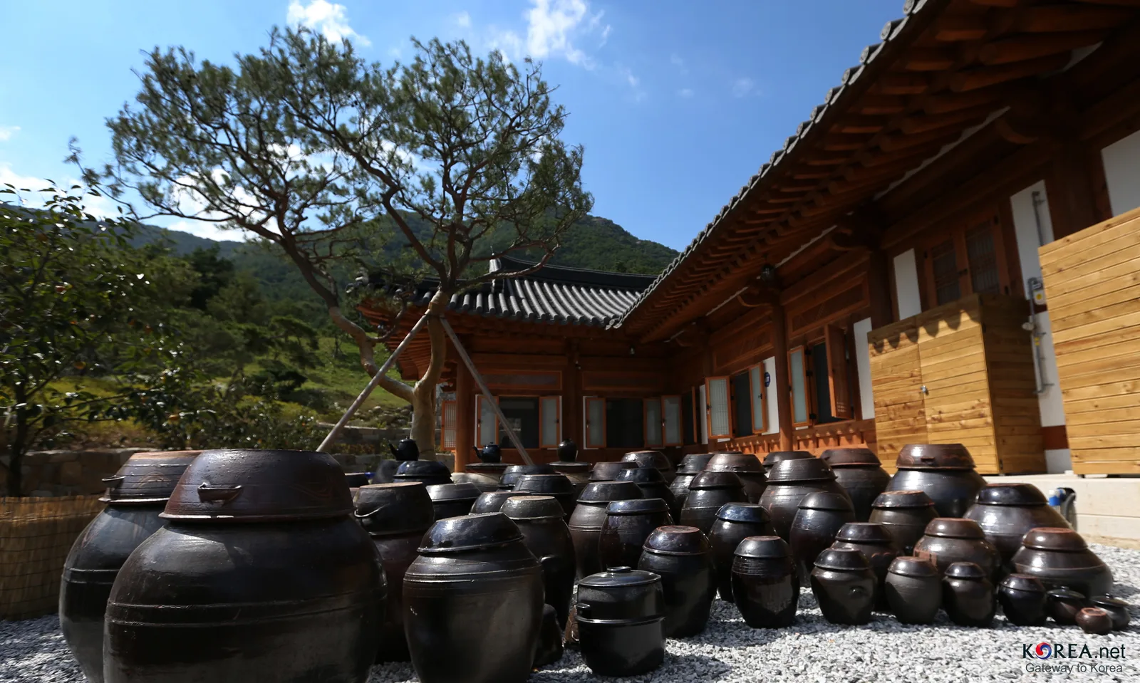 Rows of traditional medicine jars beside a hanok building at Donguibogam Village in Sancheong