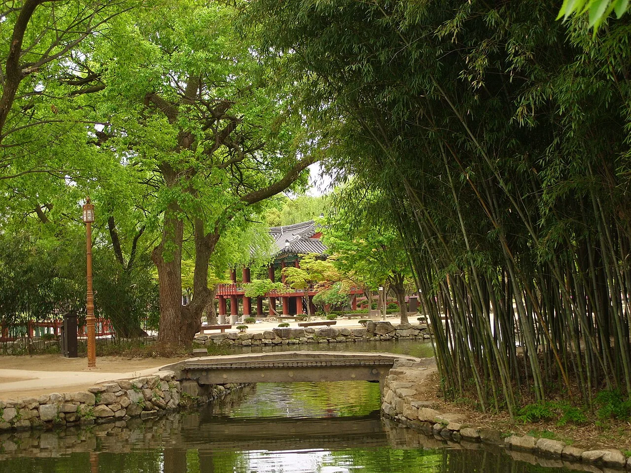 A pond, stone bridge, bamboo grove and traditional pavilion inside Gwanghalluwon Garden in Namwon