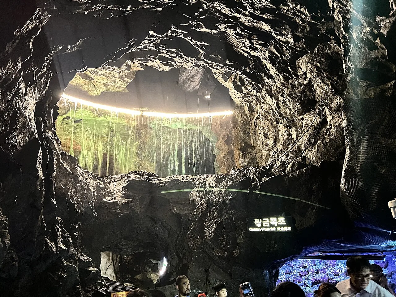 The illuminated Golden Waterfall chamber inside Gwangmyeong Cave