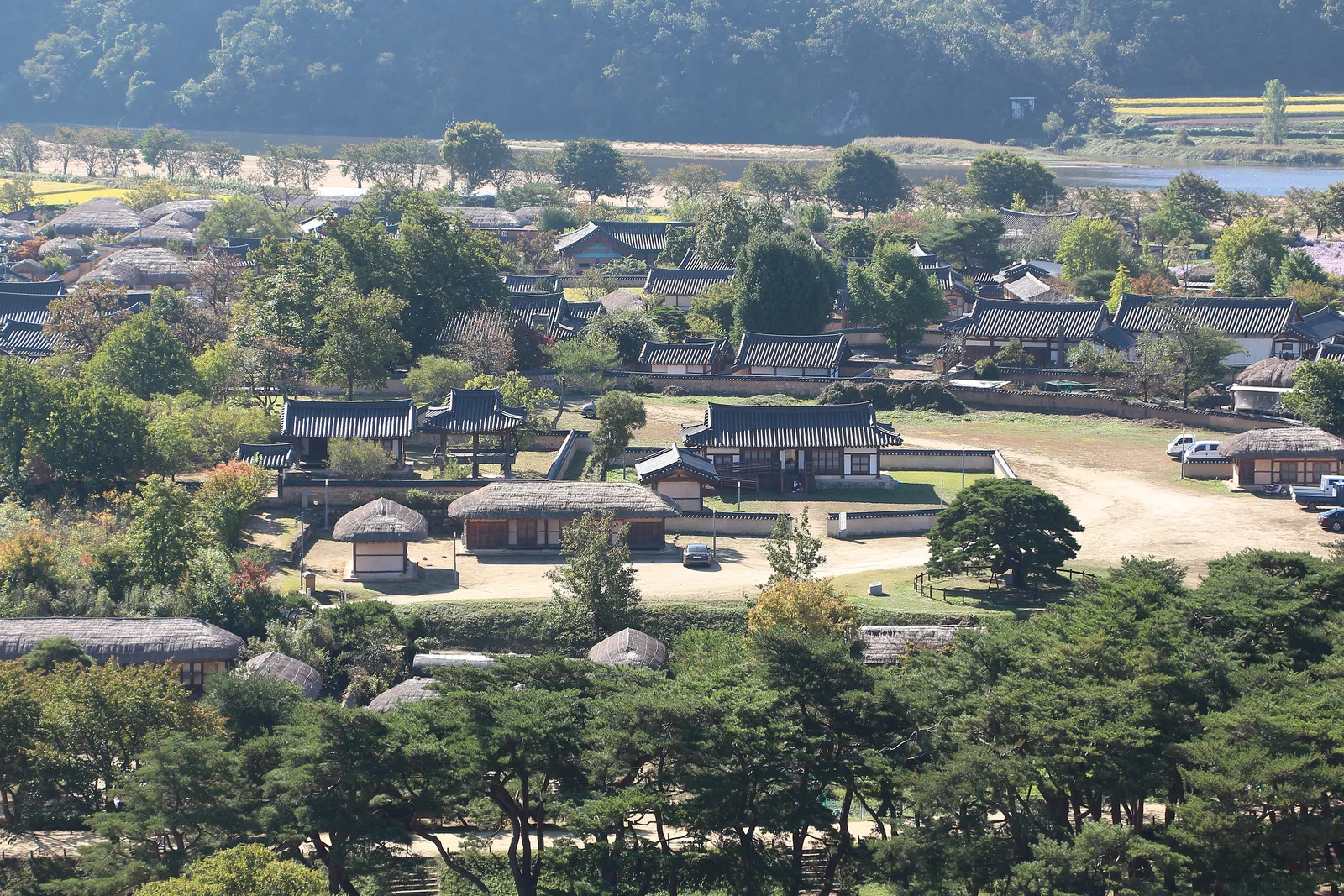 A panoramic hillside view over Hahoe Folk Village's tiled and thatched houses beside the Nakdong River