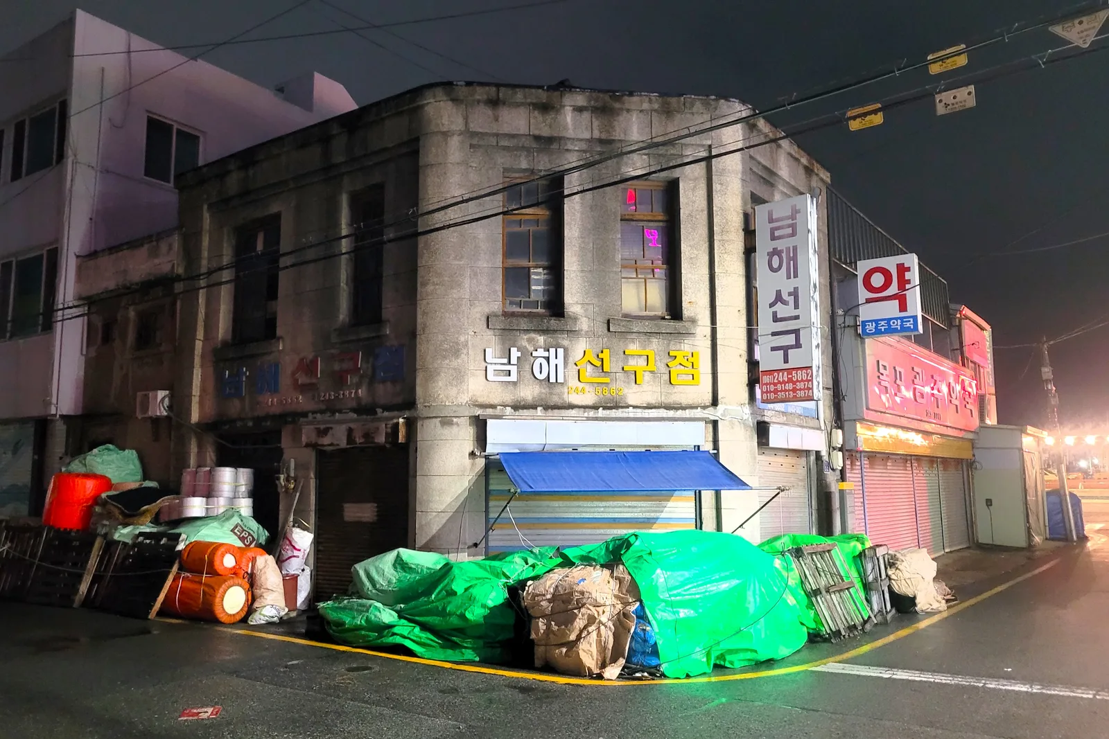 A registered early-modern commercial house illuminated at night inside Mokpo Modern History and Culture Space