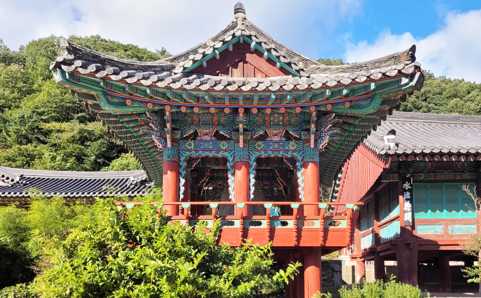 A painted timber temple hall and tiled roofs inside Sinheungsa at Seoraksan