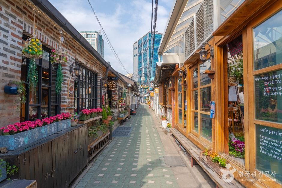 A real narrow hanok alley lined with wooden cafés and shops in Ikseon-dong, Seoul