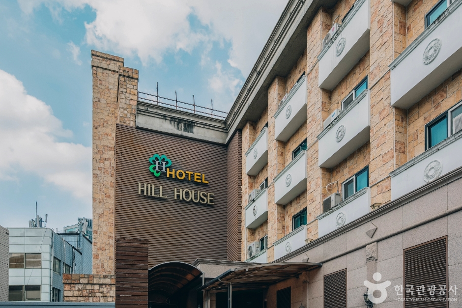 Signed stone facade of Hotel Hill House Seoul below Namsan