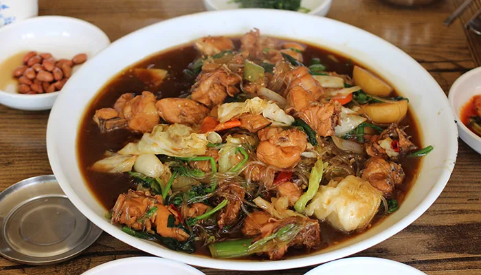 Andong-jjimdak with braised chicken, vegetables and glass noodles in dark soy sauce
