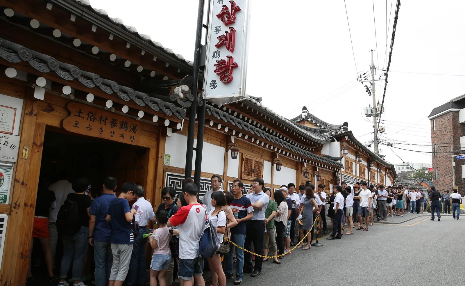 Tosokchon Samgyetang's signed hanok storefront and visitor queue photographed in Jongno in August 2016, not a live wait report