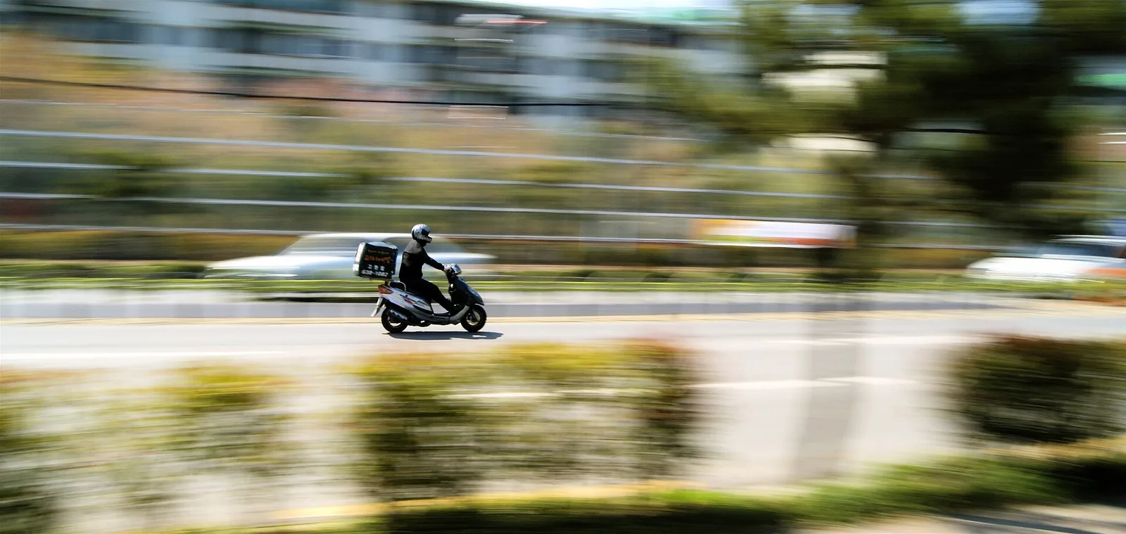 A delivery rider on a scooter in Geoje, South Korea