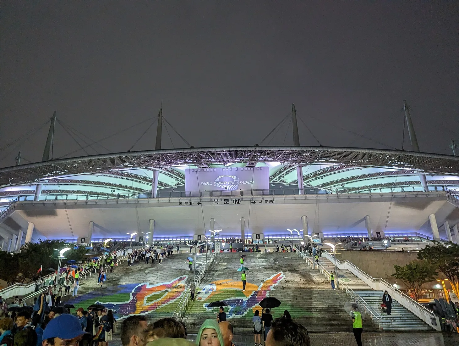 Crowds leaving Seoul World Cup Stadium after a K-pop concert at night