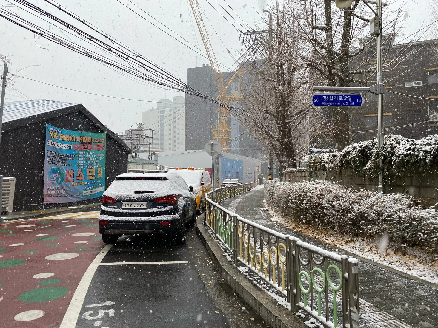 Snow falling on a street and sidewalk in Seongsu-dong, Seoul
