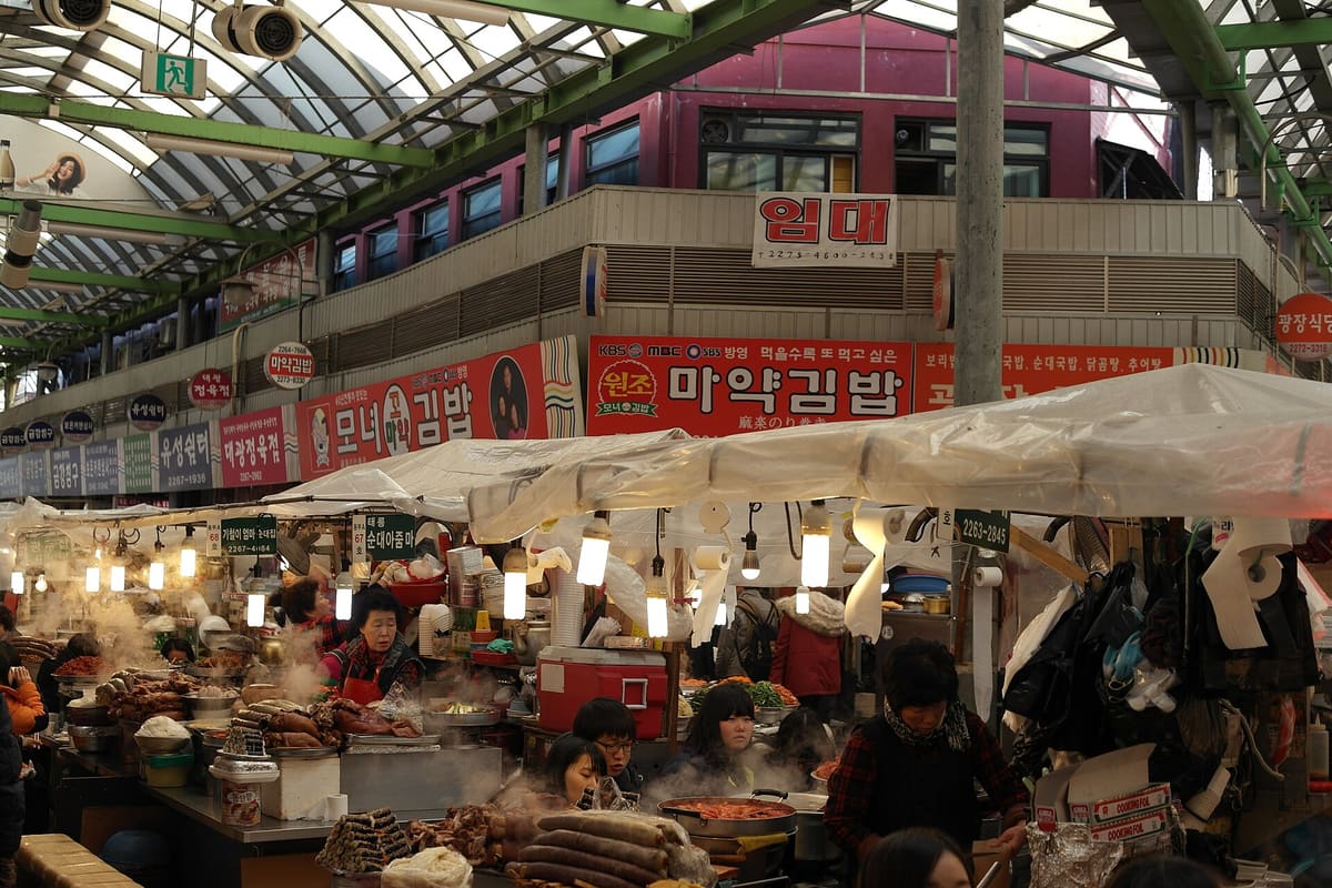 Food stalls under the covered roof of Gwangjang Market