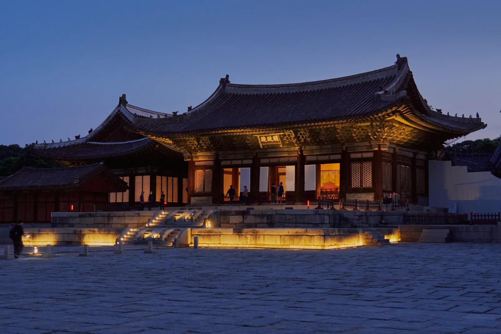 Myeongjeongjeon throne hall illuminated at dusk inside Changgyeonggung Palace in Seoul
