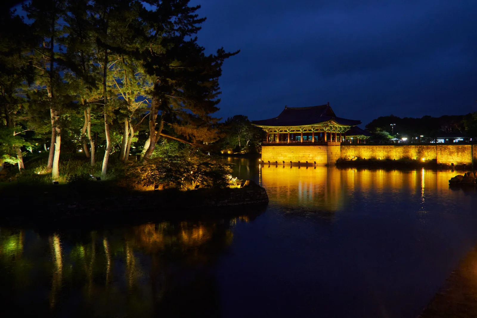 The illuminated pavilion and trees reflected across Wolji Pond at Donggung Palace in Gyeongju