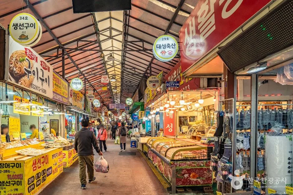 Prepared-food shops and grocery stalls beneath the covered aisle of Bucheon Wonmi General Market